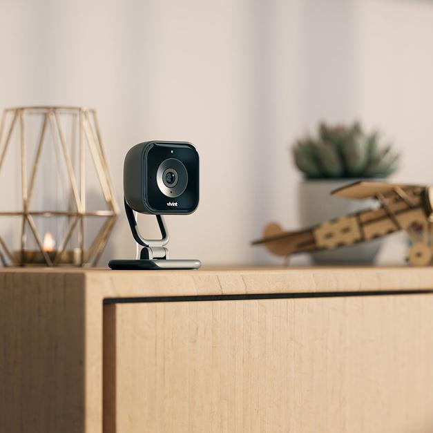 Indoor HD wireless smart security camera placed on living room bookshelf